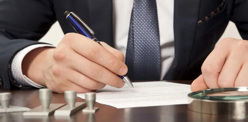 Lawyer, notary signs the documents from our office