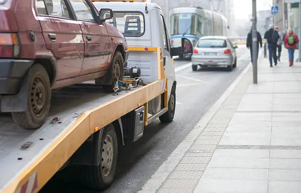 Roadside assistance car towing truck in the city